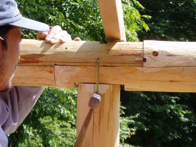 hammer a cramp iron into the joint of pole and girder