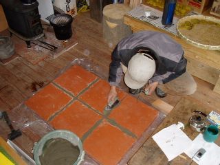 lay tiles onto the slab and finish the joints